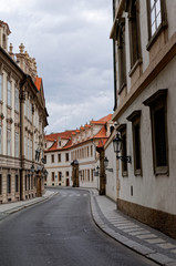 Fototapeta na wymiar Czech Republic, Prague. Street between old tenements houses with red tiles.