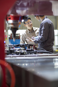 Young engineers talking in the factory