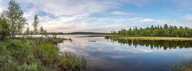 Midnight sun in Lapland.Peaceful lake view.