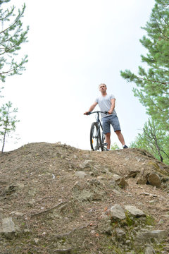Athlete on a mountain bike on the rise. Healthy lifestyle