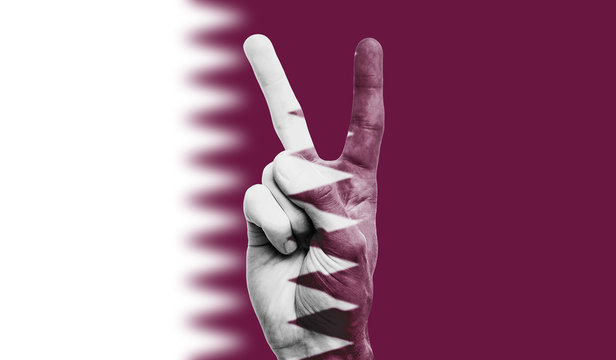 Qatar National Flag Painted Onto A Male Hand Showing A Victory, Peace, Strength Sign