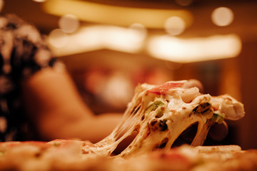 Slice of hot pizza cheese lunch or dinner crust seafood meat topping sauce. with bell pepper...
