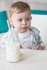 Сute little boy is eating candy and drinking milk. Health. Happy child. Breakfast. 