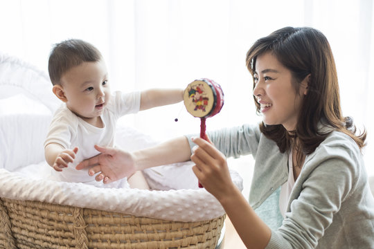 Happy mother and cute baby at home