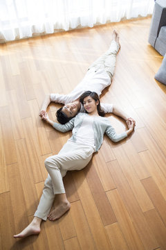 Young couple resting on wooden floor