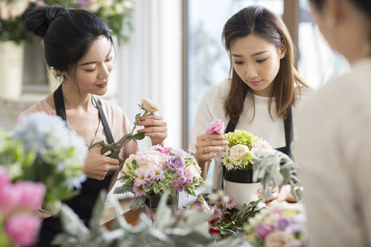 Young women learning flower arrangement