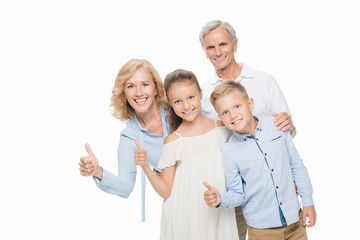 grandparents and grandchildren showing thumbs up