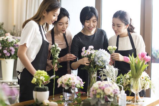 Young women learning flower arrangement