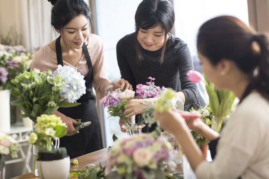 Young women learning flower arrangement