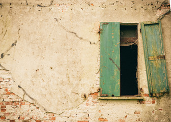 Closed Window on the Dilapidated Facade of the Old Italian House. Vintage effect.
