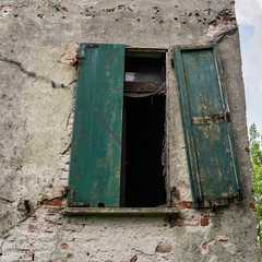 Closed Window on the Dilapidated Facade of the Old Italian House. Vintage effect.