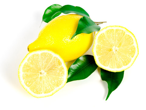 Yellow lemon with fresh green leaves over white background
