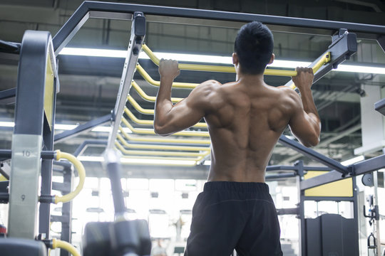 Young man exercising at gym