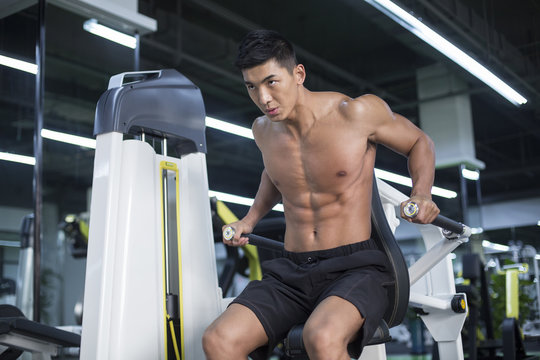 Young man exercising at gym