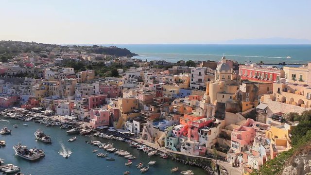Procida, Corricella marina at sunset. Panoramic view of the old village of fishermen's houses and the marina of Corricella, a classic panoramic view of the island of Procida, Italy.