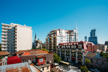 Obraz premium Modern Houses Rise Above The Old Rusty Roofs In Batumi, Adjara Georgia