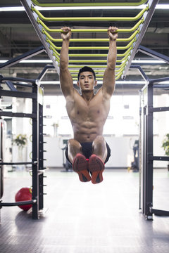 Young man exercising at gym