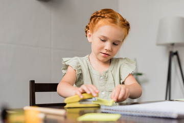 little girl with stapler