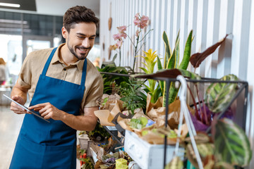 male florist with digital tablet