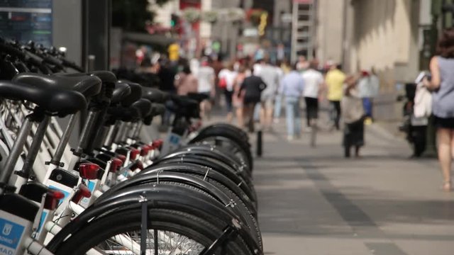 The public bicycles in center of Madrid and pedestrians