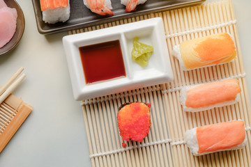 Sushi set / View of japanese food on light blue tile. Sushi set. Top view.