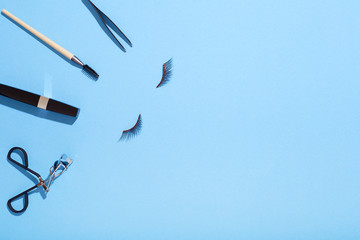 Makeup for eyes flat lay on blue background