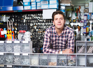 Adult man buyer looking switches for light and sockets in the shop
