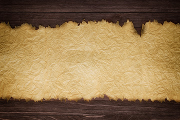 Old paper sheet on wooden wall background