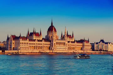 Fototapeta premium Budapest Parliament building and Danube river at sunset, travel Hungary background