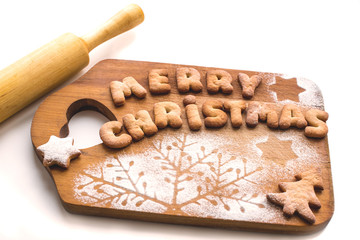 Merry Christmas! Gingerbread Cookies in the form of words on a cutting board