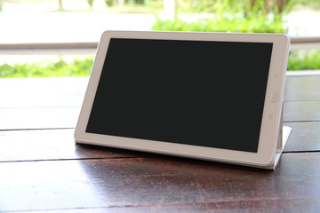 Tablet screen on wooden table,copy space.