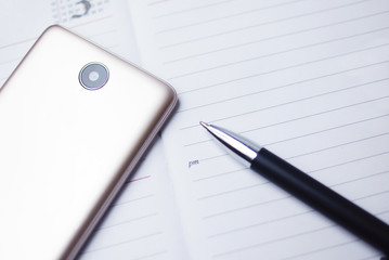 Smartphone And Ballpen Over Management Diary