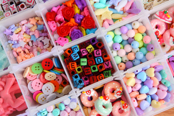 handcraft colorful flower, alphabet and animal  bead in box  background