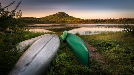 Sundown on canoes in front of Alford Pond and Mt Seymour at Lake Placid, New York, in the...