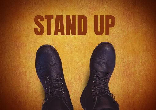 Stand up  text  and black shoes on feet with rustic brown  backg