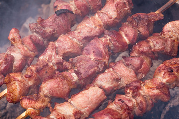 closeup of some meat skewers being grilled in a barbecue