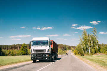 Fototapeta na wymiar Truck In Motion On Country Road. Motion Cars On Freeway In Europe