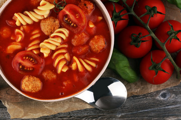 Tomato soup with meatballs in a bowl. Italian minestrone soup