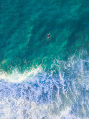 One man going to surf in the morning in clear water beach
