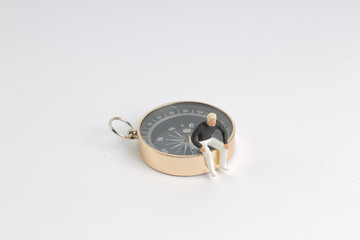 model miniature on compass on white back ground