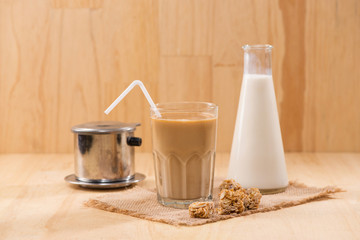 Coffee with milk on a wooden table.