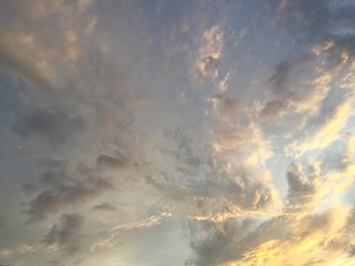 Golden sunlight on cloudy blue sky background