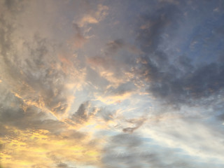 Golden sunlight on cloudy blue sky background