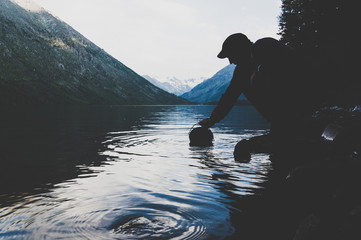 tourists taking water from freshwater lakes into the pot for cooking