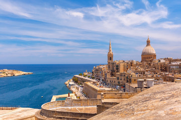 View from above of the domes of churches and roofs with church of Our Lady of Mount Carmel and St. Paul's Anglican Pro-Cathedral, Valletta, Capital city of Malta - obrazy, fototapety, plakaty