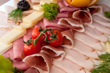 Catering food with cherry tomatoes, ham, and salami