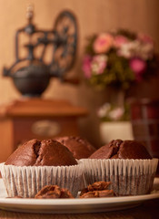 Chocolate muffins in white forms on a white plate