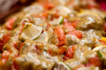 Fresh salmon salad served on a wide plate on a table
