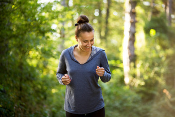 Girl smiling while running in the forest