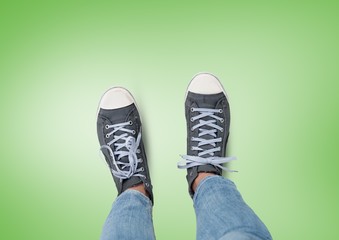 grey shoes on feet with green background
